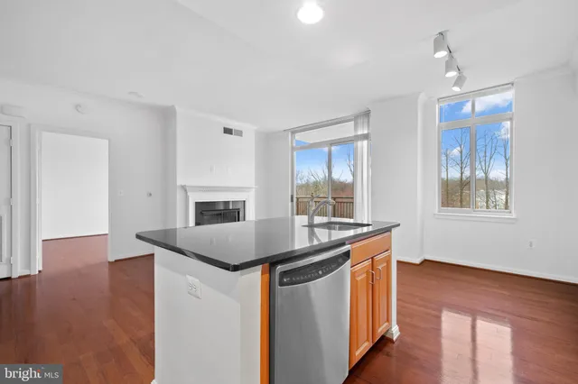 a kitchen with sink cabinets and wooden floor