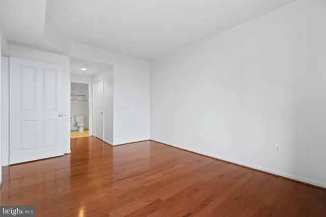 a view of an empty room and wooden floor
