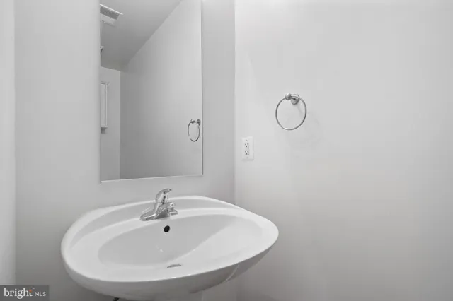 a bathroom with a sink and mirror