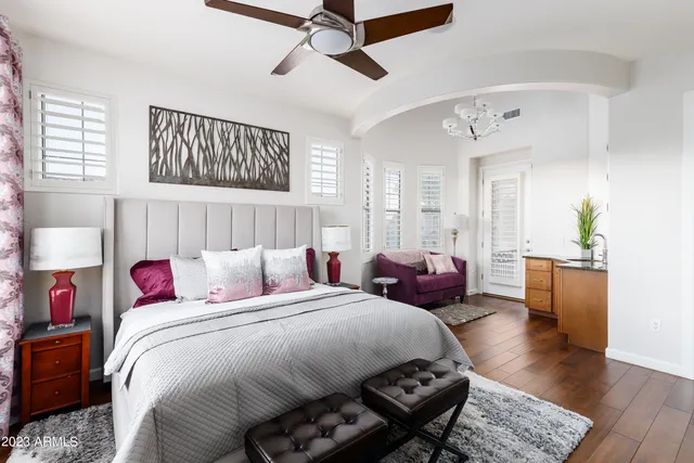 a bedroom with bed and a chandelier