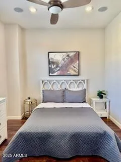 a bedroom with a bed and a painting on the wall