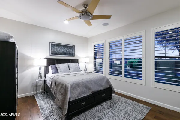 a bedroom with a large bed a chandelier and a window