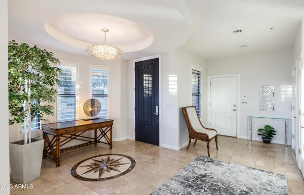 a living room with furniture a dining table and a chandelier