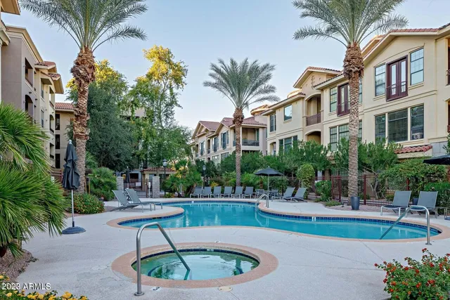 a swimming pool with outdoor seating and yard