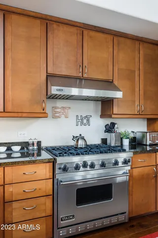 a kitchen with stainless steel appliances granite countertop a stove and a sink