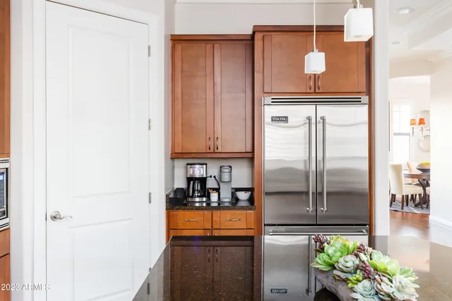 a kitchen with stainless steel appliances granite countertop a refrigerator and a stove