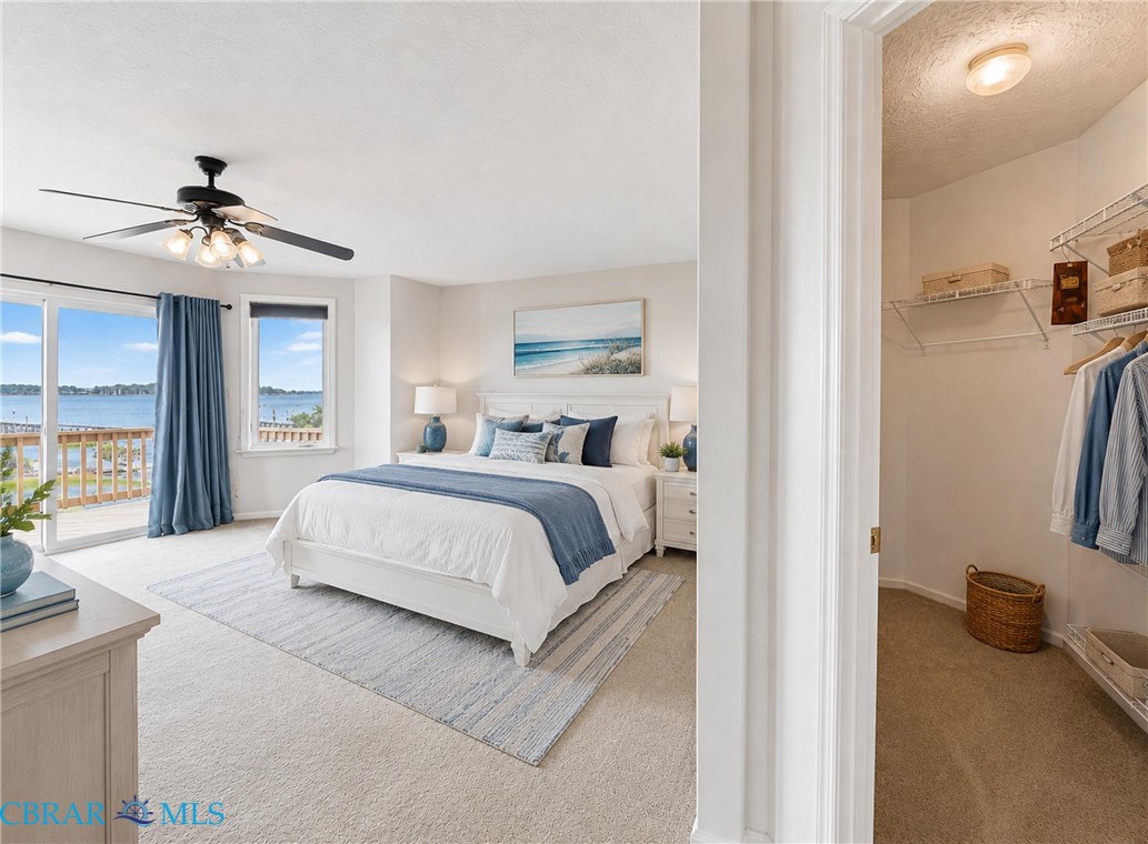 1214 Dandy Loop Road Yorktown, VA 23692 - Photo 45 of 65 a bedroom with a bed and a chandelier