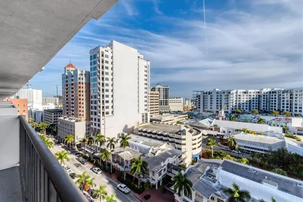 a view of a dining room with furniture and a large window