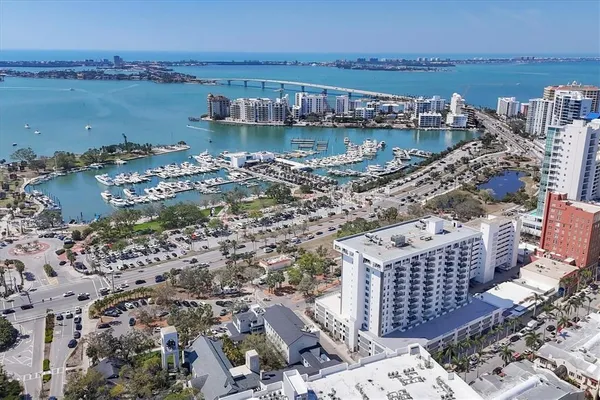 a view of a lake with a yard and large trees