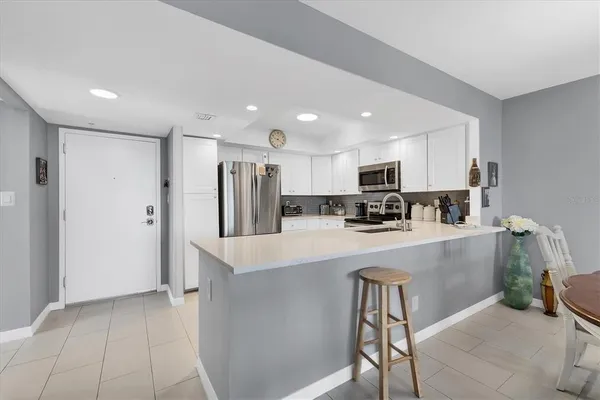 a kitchen with sink and white cabinets
