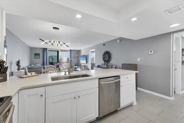 a living room with furniture large windows and a rug