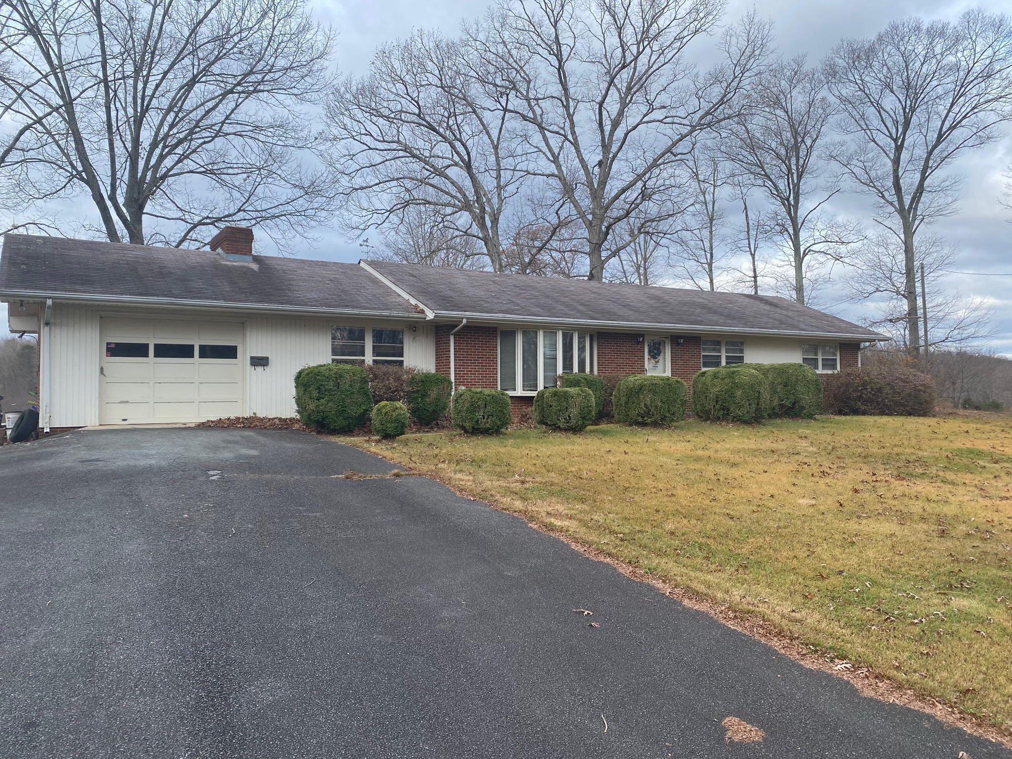 2097 Sandy Level Road Goodview, VA 24095 - Photo 1 of 43 a front view of a house with a yard and garage