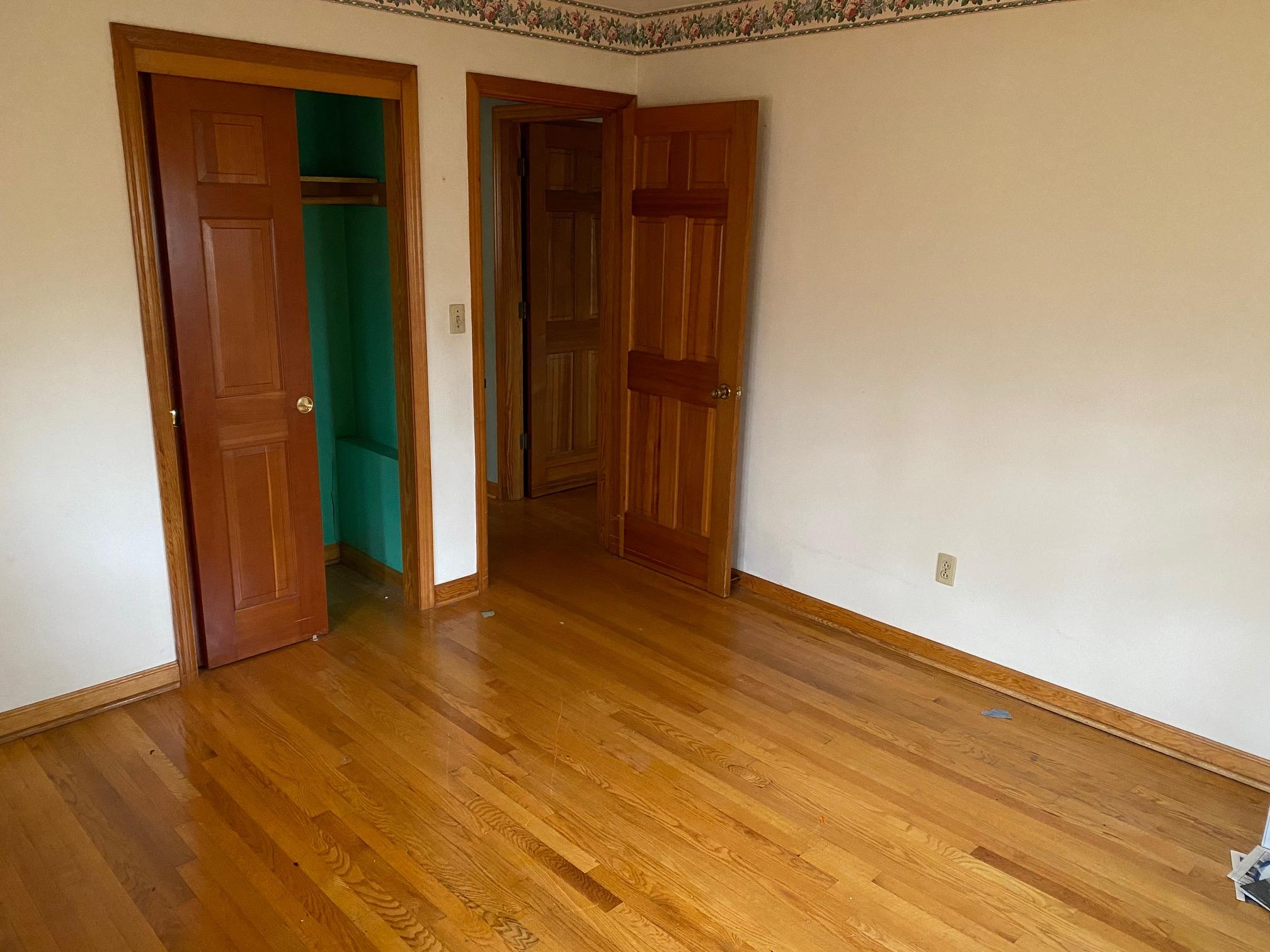 2097 Sandy Level Road Goodview, VA 24095 - Photo 7 of 43 an empty room with wooden floor and closet