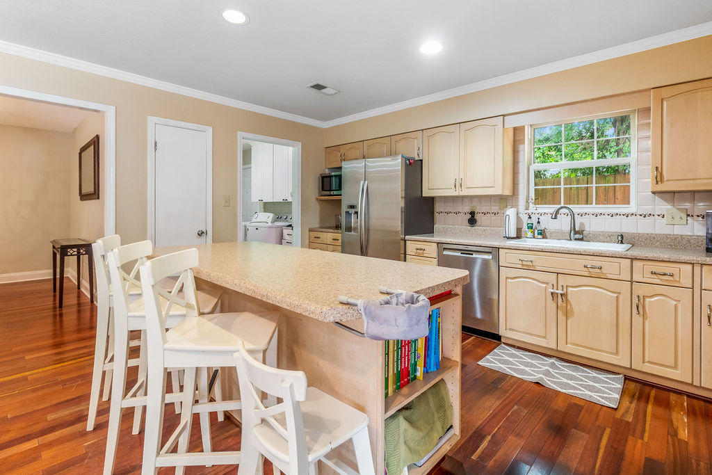2135 Semur Road Pensacola, FL 32503 - Photo 12 of 37 a very nice looking kitchen with granite countertop a stove top oven a sink a dining table and chairs