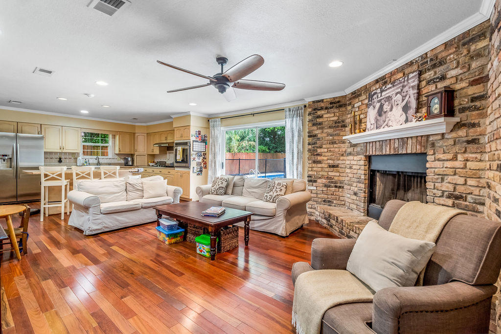 2135 Semur Road Pensacola, FL 32503 - Photo 15 of 37 a living room with furniture wooden floor and a fireplace