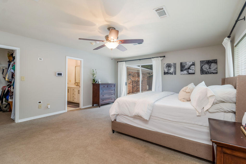 2135 Semur Road Pensacola, FL 32503 - Photo 34 of 37 a bedroom with a large bed and a chandelier