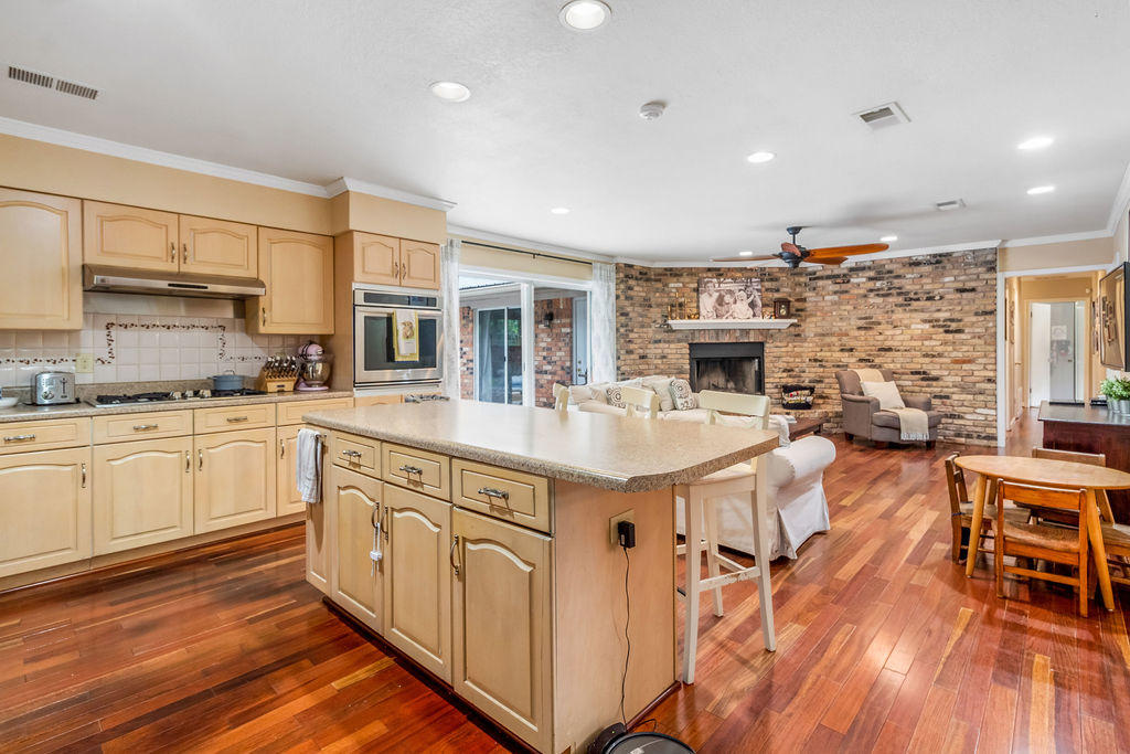 2135 Semur Road Pensacola, FL 32503 - Photo 9 of 37 a kitchen with stainless steel appliances granite countertop a lot of counter space and wooden floors