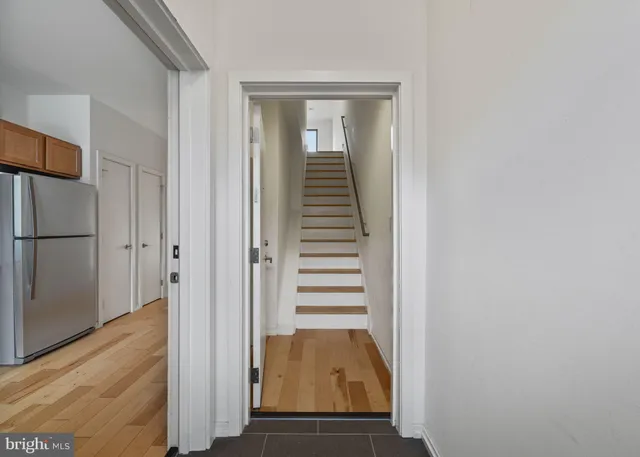 a view of a hallway with wooden floor and staircase
