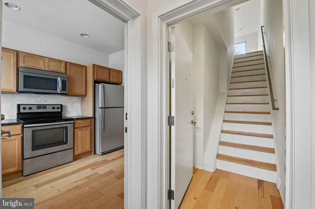 a kitchen with a refrigerator and a stove top oven