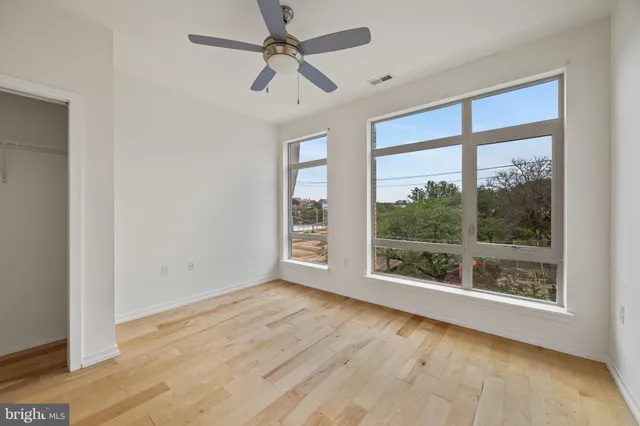 a view of room with window and wooden floor