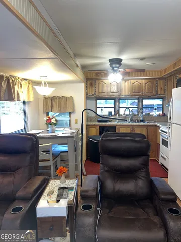 a dining room filled with furniture and a window