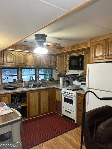 a kitchen with a sink appliances and cabinets