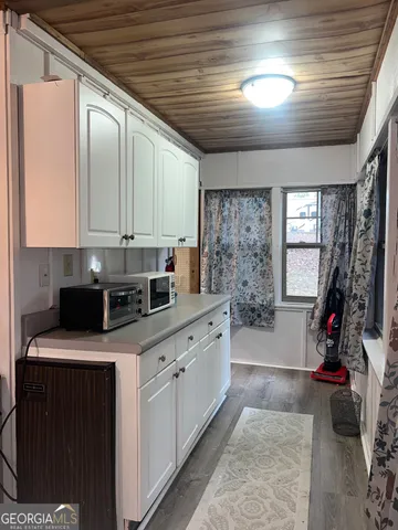 a kitchen with a stove a sink and cabinets