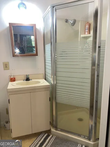 a bathroom with a sink a mirror and shower