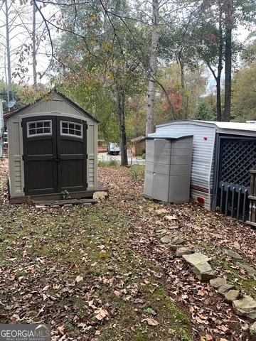 a view of a house with a yard and a tree