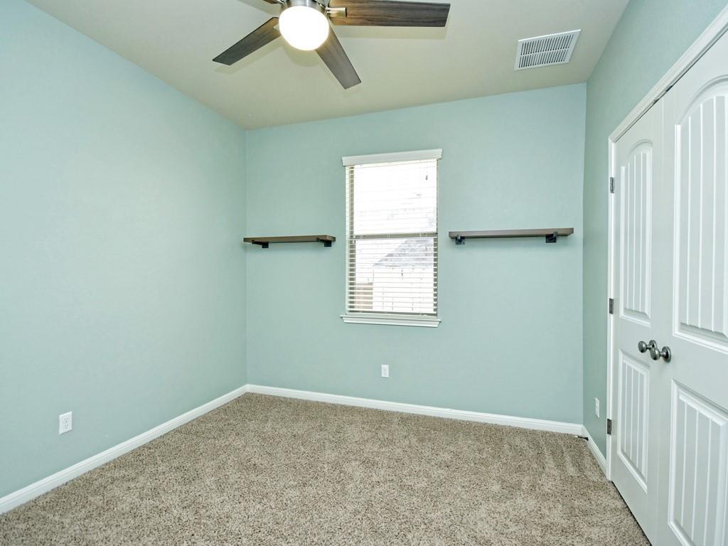 2216 Lookout Range Drive Leander, TX 78641 - Photo 12 of 16 Unfurnished bedroom with carpet floors, a closet, and ceiling fan