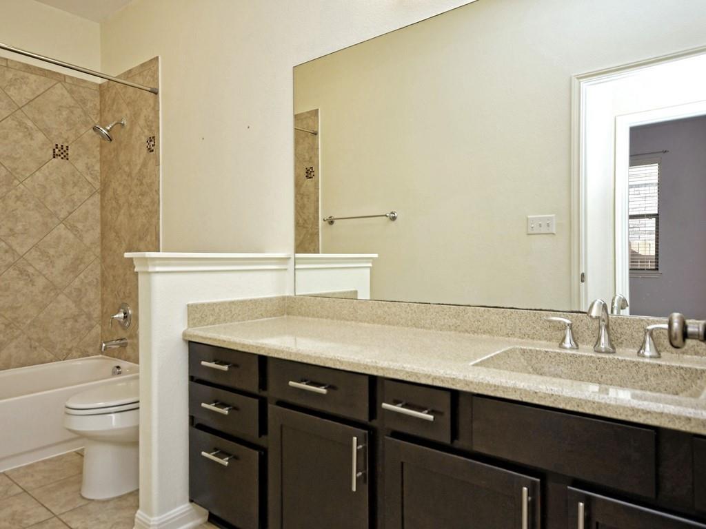 2216 Lookout Range Drive Leander, TX 78641 - Photo 13 of 16 Bathroom with vanity, shower / bathtub combination, and light tile patterned flooring