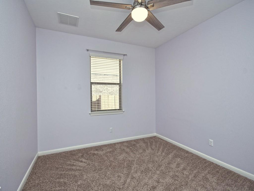 2216 Lookout Range Drive Leander, TX 78641 - Photo 14 of 16 Carpeted empty room with baseboards and ceiling fan