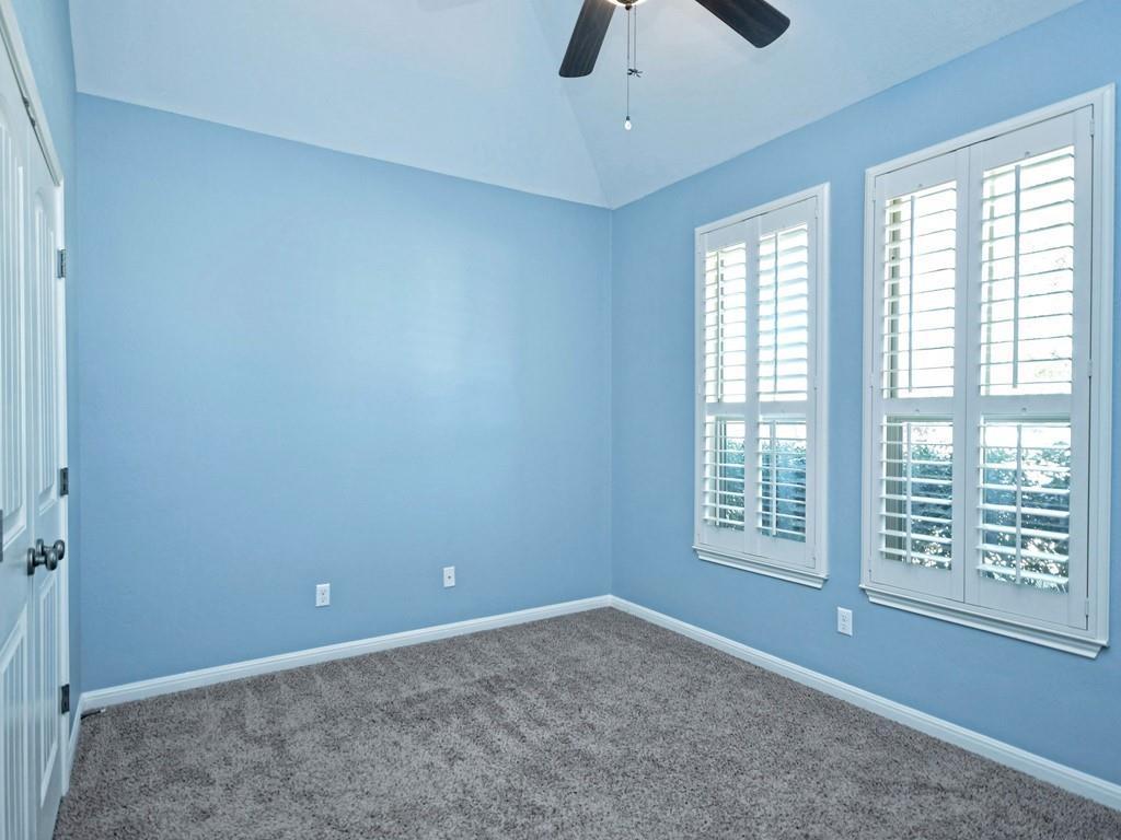 2216 Lookout Range Drive Leander, TX 78641 - Photo 15 of 16 Unfurnished bedroom featuring a closet, vaulted ceiling, carpet floors, and ceiling fan