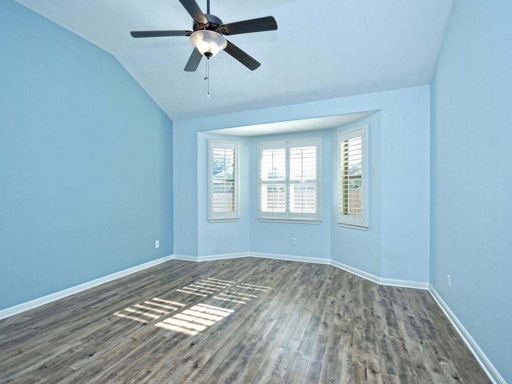 2216 Lookout Range Drive Leander, TX 78641 - Photo 9 of 16 Spare room featuring dark wood-style flooring, lofted ceiling, and a ceiling fan