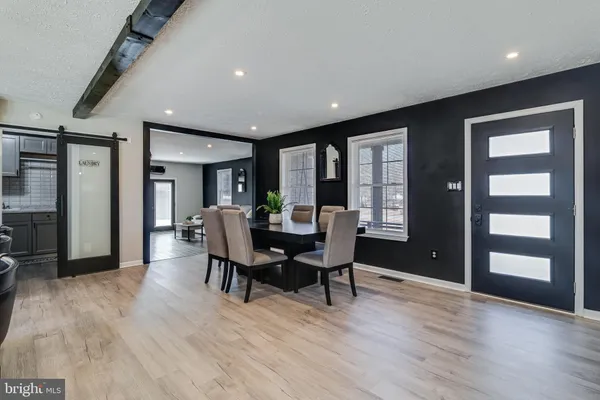 a view of a a dining room with furniture window and wooden floor