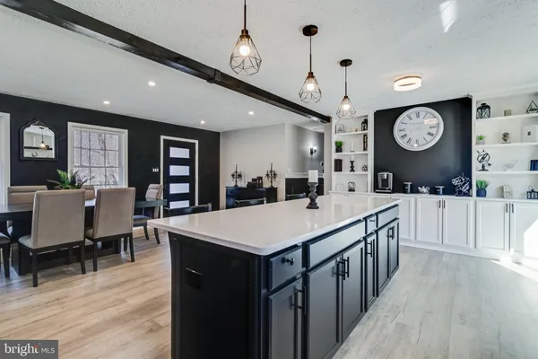 a large kitchen with a table and a large window