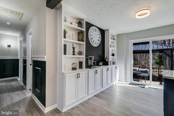 a view of a kitchen with fridge and wooden floor