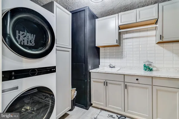a utility room with sink dryer and washer