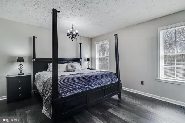 a bedroom with a bed table and window