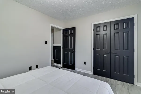 a bedroom with a bed and a mirror