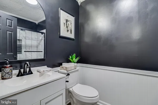 a bathroom with a sink mirror vanity and toilet