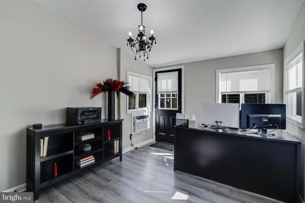 a kitchen with granite countertop a refrigerator dining table and chairs