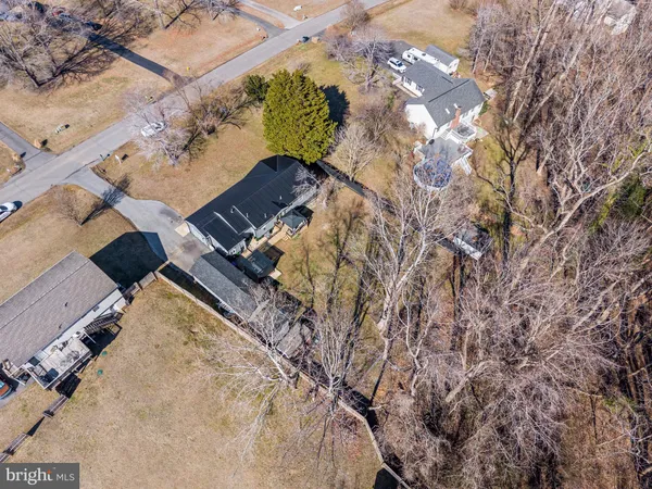 an aerial view of a house with a yard and covered with snow