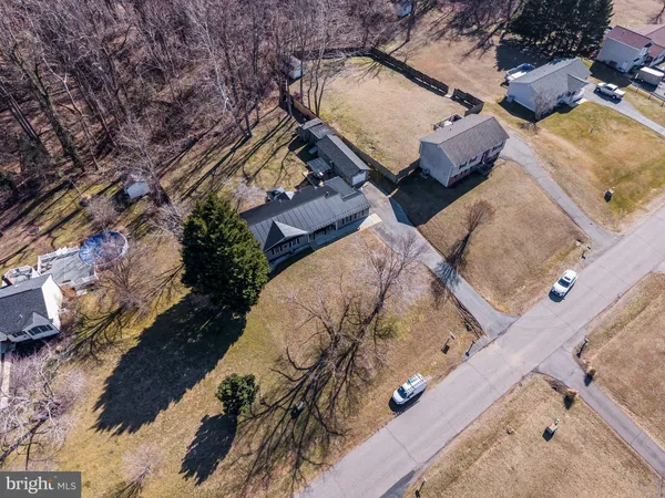 an aerial view of a house with a yard