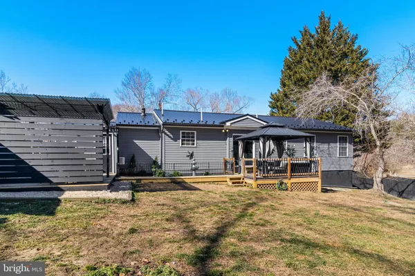 a backyard of a house with barbeque oven table and chairs
