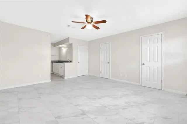 an empty room with closet and windows