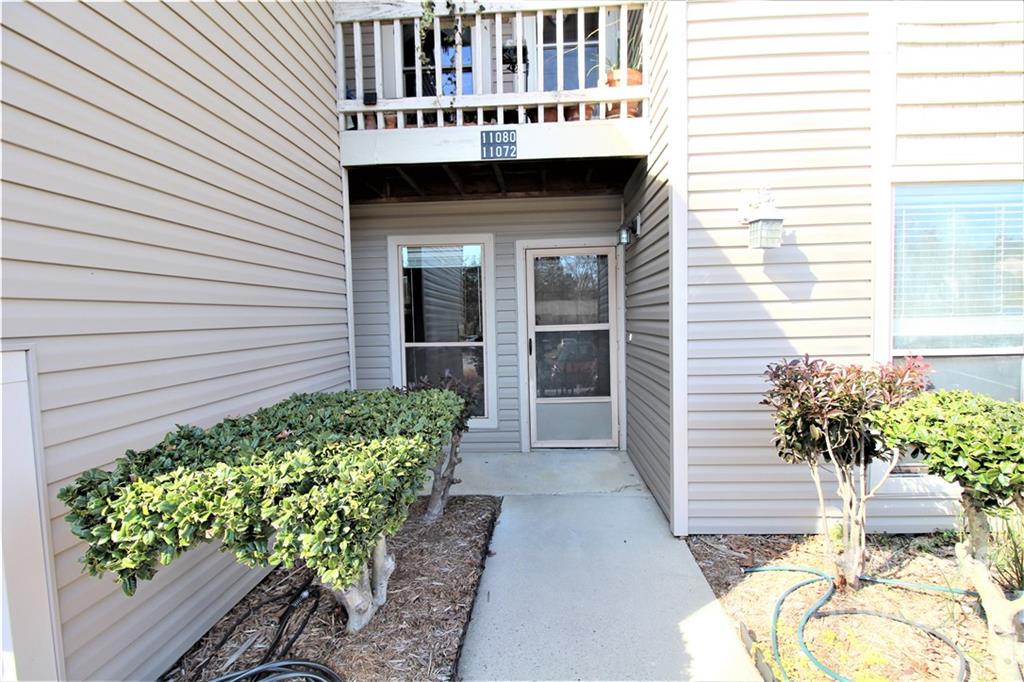 11072 Cedar View Road Charlotte, NC 28226 - Photo 2 of 18 a front view of a house with a garden