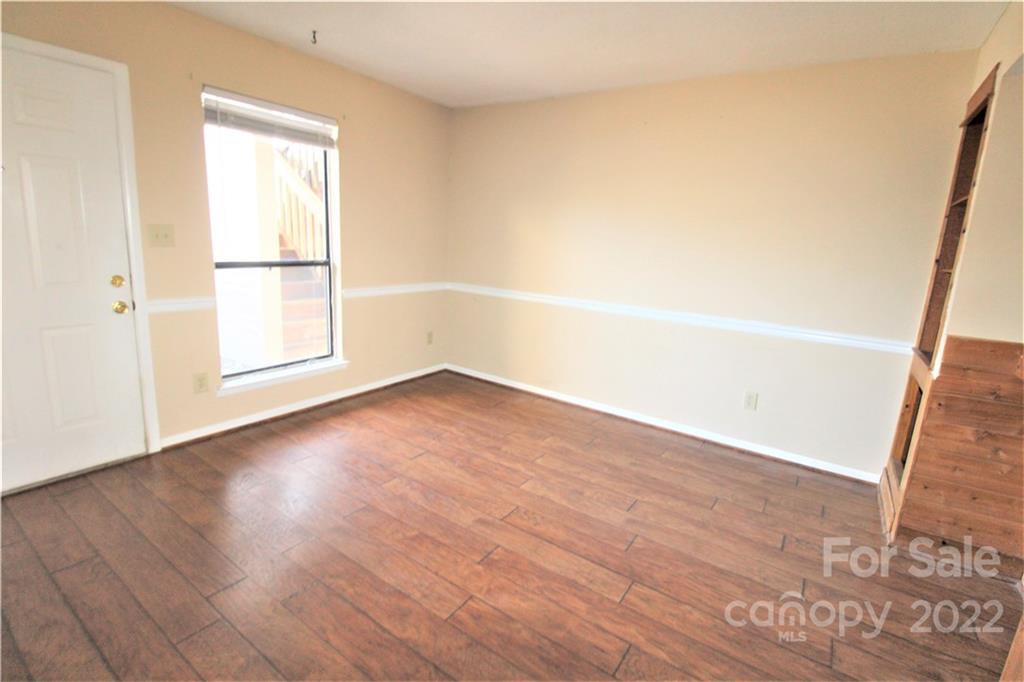 11072 Cedar View Road Charlotte, NC 28226 - Photo 4 of 18 an empty room with wooden floor and windows
