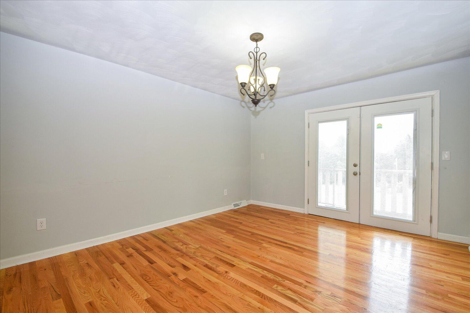 1316 Dudley Road Moneta, VA 24121 - Photo 11 of 37 a view of empty room with wooden floor and fan