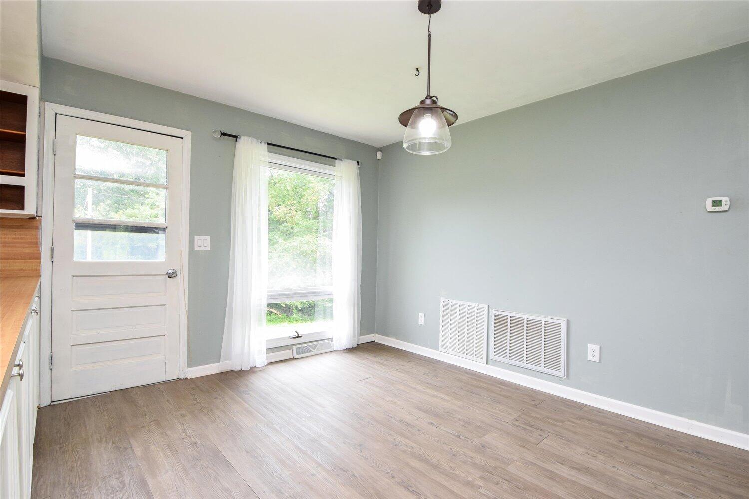 1316 Dudley Road Moneta, VA 24121 - Photo 12 of 37 an empty room with wooden floor and window